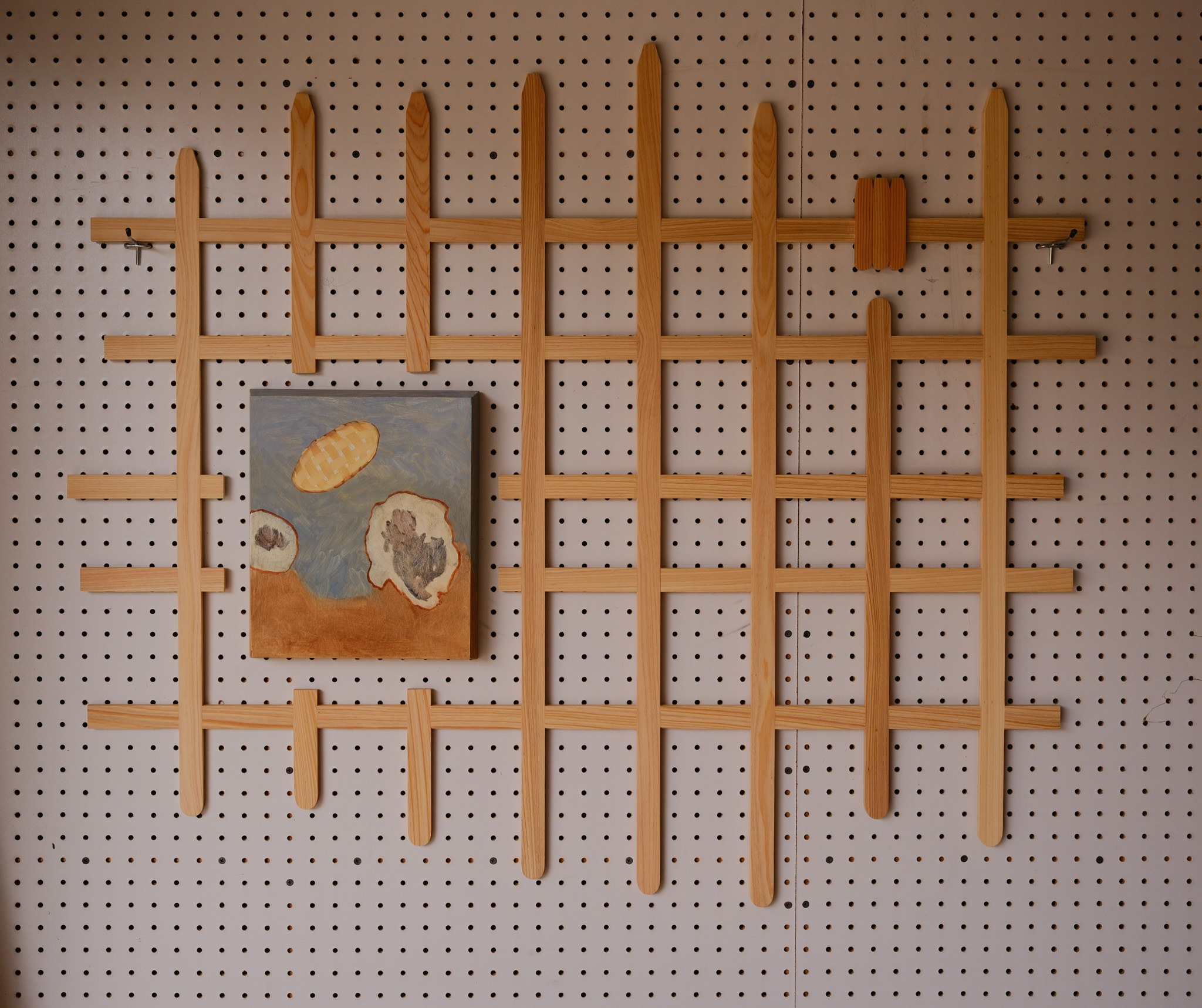 Flighty Grid: wooden lattice installation holding a small painting