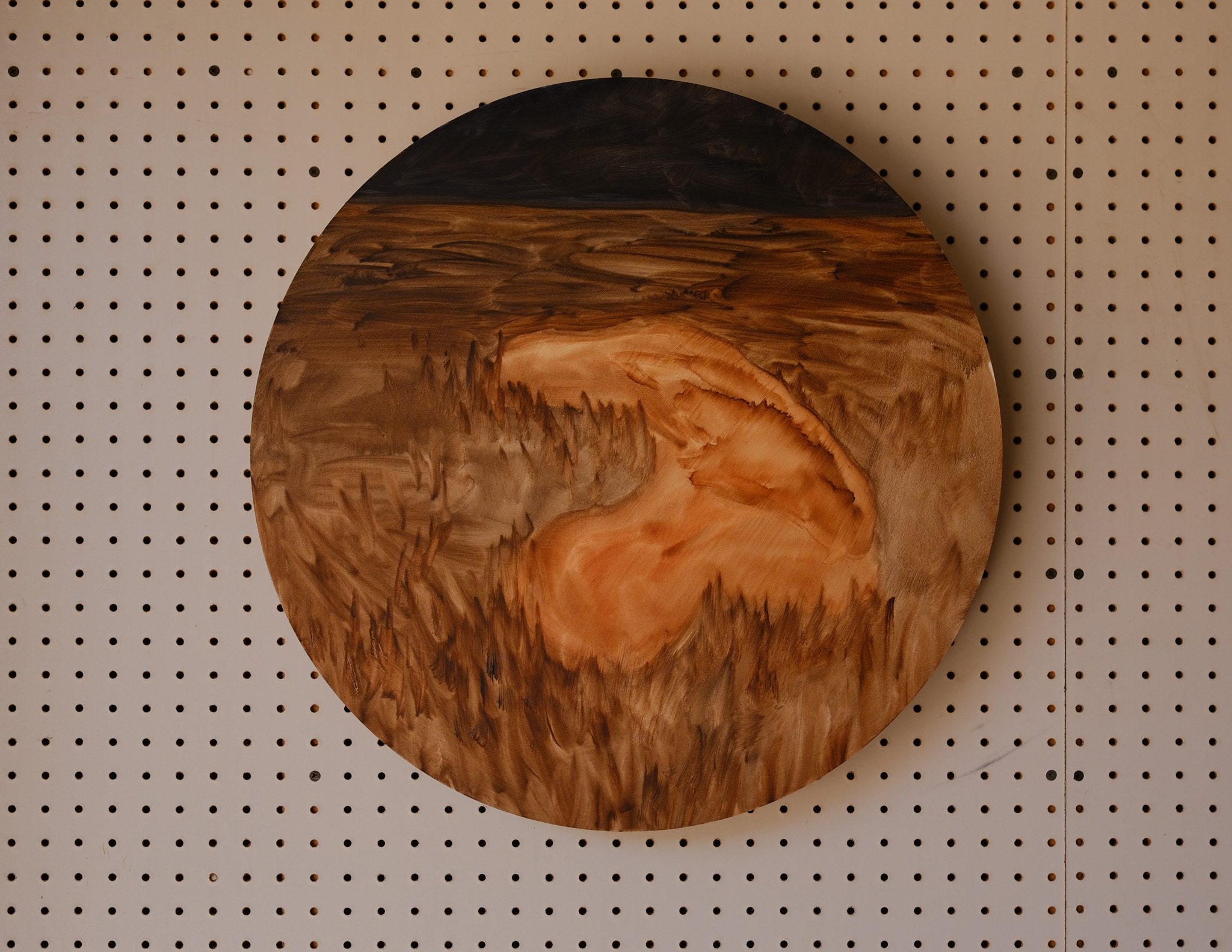 Space Blob: round panel, dark horizon over a stained brown field